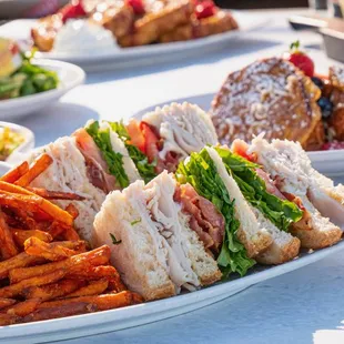 Delicious club sandwich with sweet potato fries!