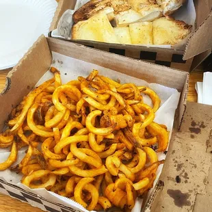 Curly fries and garlic bread.