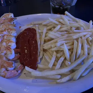 Grilled Shrimp and Fries - Alright - I asked for Blackened Shrimp but our waiter was a ditz. They charged me 50¢ for cocktail sauce.