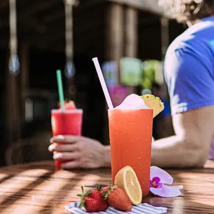 a person sitting at a table with a drink