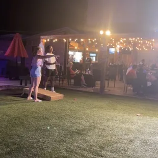 Cornhole, covered and uncovered sitting areas.