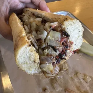 Hot pastrami sandwich with pepperjack cheese, grilled onions and spicy mayo