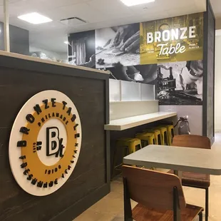 a restaurant with a large sign on the wall