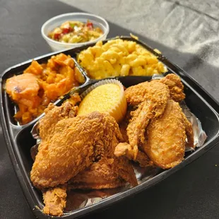 Fried chicken wings, macaroni and cheese, candied sweet potatoes, fried cabbage, cornbread muffin