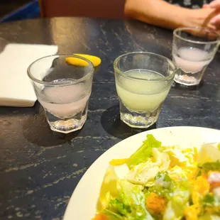 a plate of salad and two glasses of water
