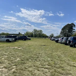 several vehicles parked in a field