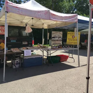 a man sitting under a tent