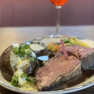 Friday special lb Prime Rib medium rare with a loaded baked potato and a berry fizz mimosa.