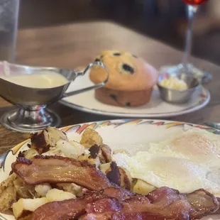 Bacon and eggs, sausage gravy, blueberry  muffin and berry fizz mimosa