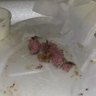 Pieces of the burger he had to spit out because he said "something doesn't taste right AT ALL!!"