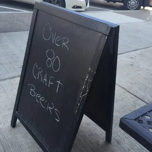 a chalkboard sign on a sidewalk