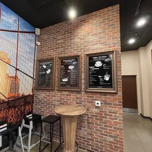 a brick wall with a mural of the brooklyn bridge