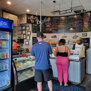 a man and a woman standing in front of the counter