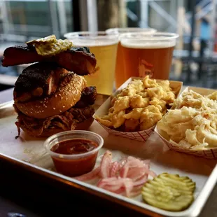 a tray of food and a glass of beer