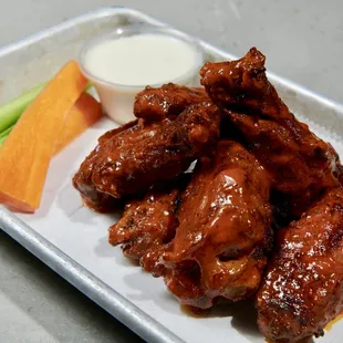 chicken wings and carrots on a plate