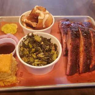 Garlic chips, collard greens, ribs, and cornbread
