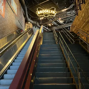 the escalator and stairs leading to the upper level
