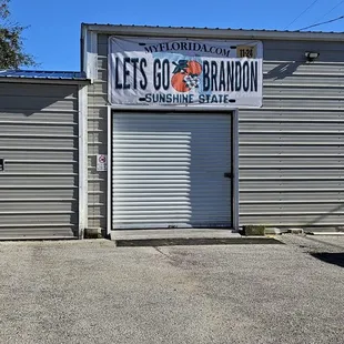 a garage with a sign that says let's go brandon