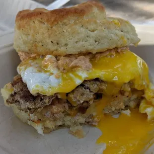 Buttermilk biscuit sandwich with fennel sausage, pimento cheese, and dill pickles