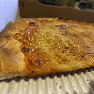 Close up of our cheese pizza crust- top of the crust was almost too hard to chew -old dough?