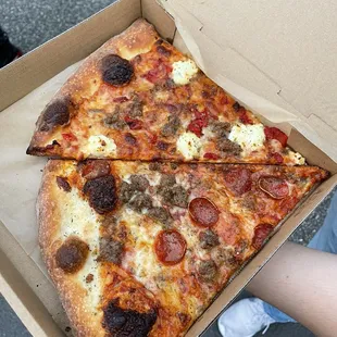 two slices of pizza in a box