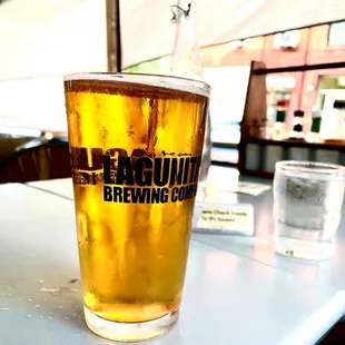 a glass of beer on a table