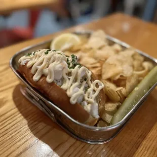 a hot dog with a side of chips