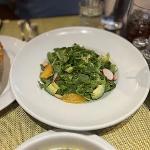 a plate of salad and a sandwich