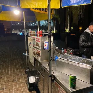 a man selling food from a food cart