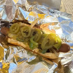 a hot dog with onions and peppers