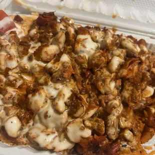 Chicken over rice with extra white sauce and hot sauce