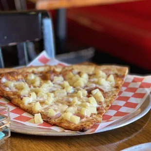 two slices of pizza on a paper plate