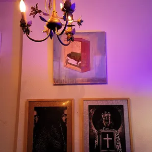 a chandelier and three framed pictures