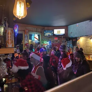 a large group of people wearing santa hats