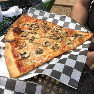 a slice of pizza with mushrooms on it