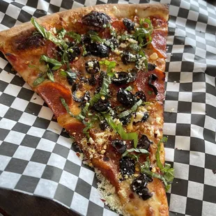 a slice of pizza on a checkered paper