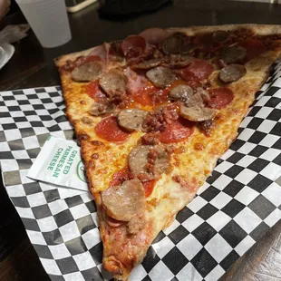 a slice of pizza on a checkered paper