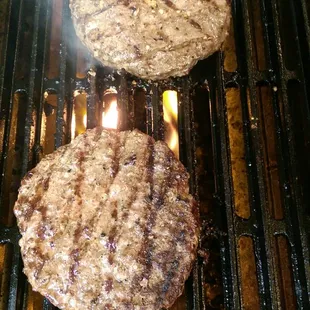 Half pound beef pattie on the griddle