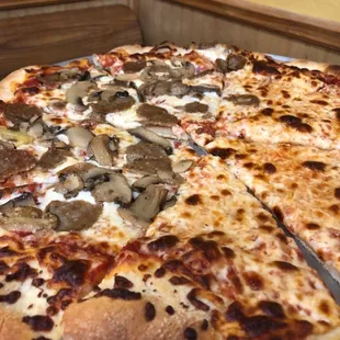 a sliced pizza with mushrooms and cheese