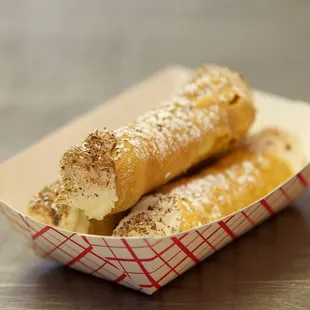 two doughnuts in a paper container