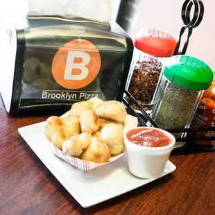 a plate of doughnuts and dipping sauce