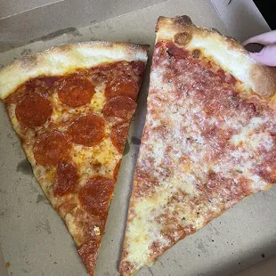 two slices of pepperoni pizza in a box