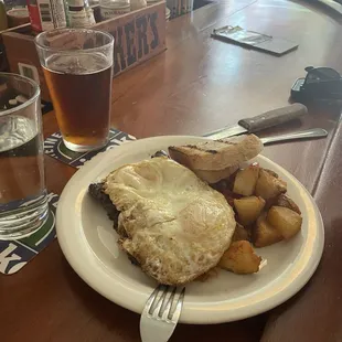 Steak and Eggs, subbed the fries for home fries. Can't see the steak but it's BIG and marinated deliciously. Cooked medium as requested.