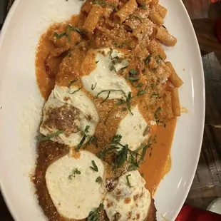 Filet mignon Vodka parmesan with smoked mozzarella, cherry peppers, Caramelized Onions and rigatoni pasta