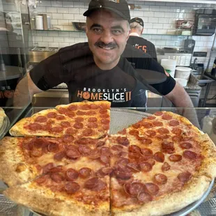 One of the partners in front of one of our pizza selections