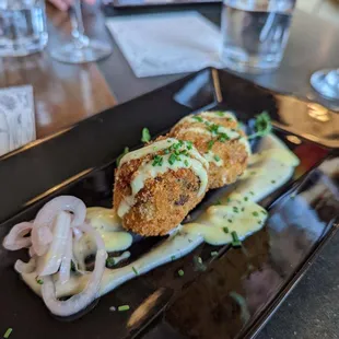 vegan mushroom fritters with dill aioli, pickled shallot, and lemon sabayon.