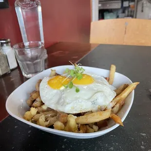 Breakfast Poutine with Lardons, Carmelized Onions, and Eggs