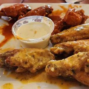 a plate of chicken wings and dipping sauce