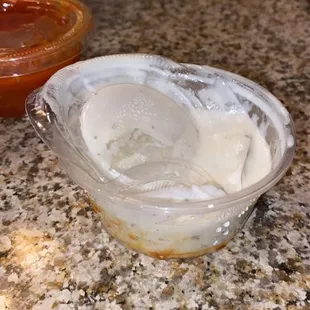 a bowl of ice cream next to a bowl of ketchup