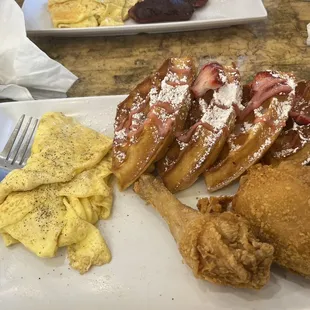 Strawberry waffles with chicken and a side of scrambled eggs. Mates beef sausage was terribly burnt.
